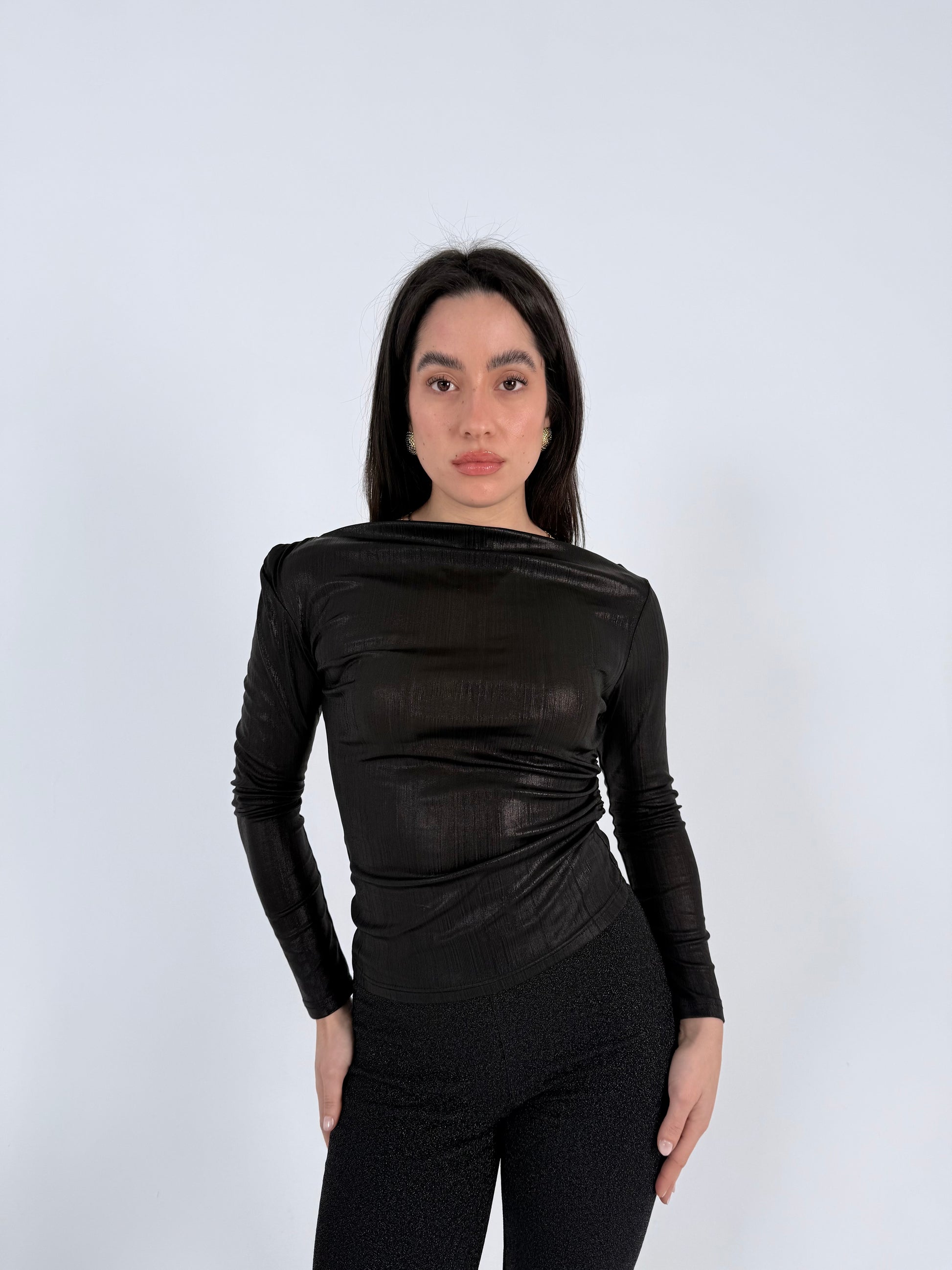 women wearing a black long-sleeve top and a gliterred pants