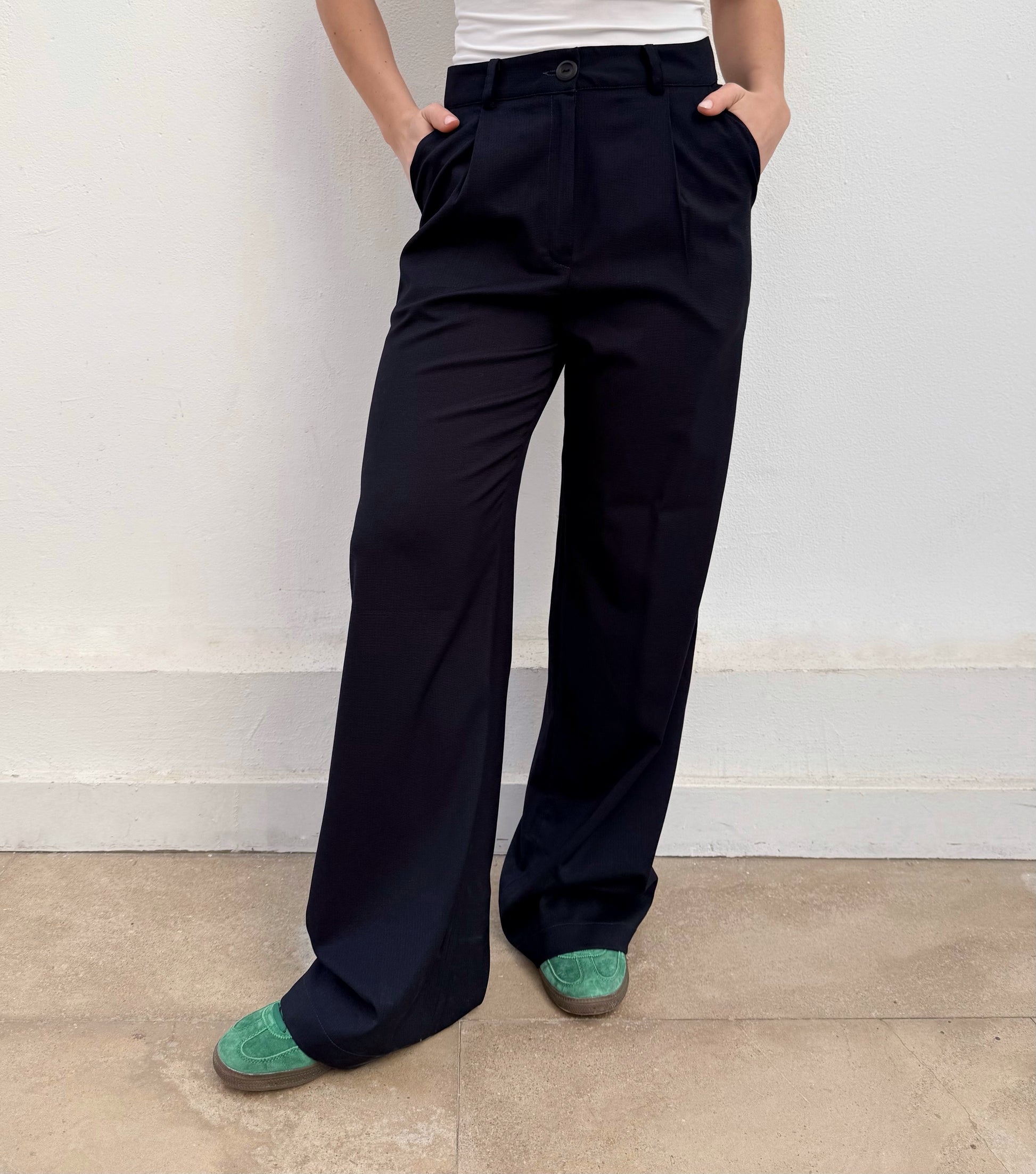 women wearing black wide-leg pants with green shoes 